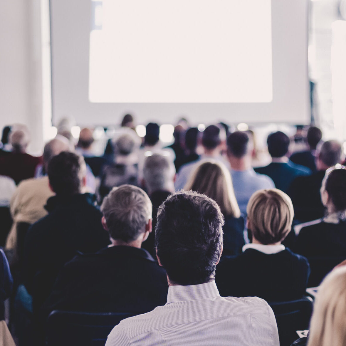 Speaker Giving a Talk at Business Meeting. Audience in the conference hall. Business and Entrepreneurship. Panoramic composition suitable for banners.